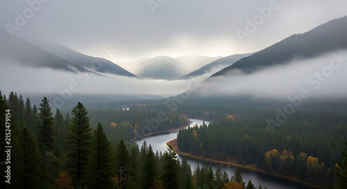 Misty mountain valley with winding river through evergreen forest during autumn mist