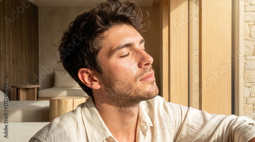 Relaxed Young Italian Man with Eyes Closed in Sunlight for Spa Wellness