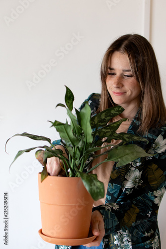 Konstfotografi Woman holds potted plant with care and gentleness