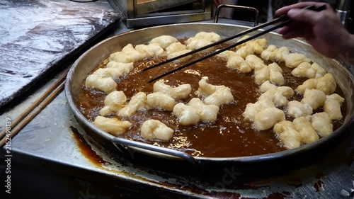 You tiao or Chinese Doughnut. Making Chinese deep-fried fluffy dough sticks.