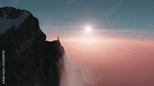 Lone Figure on Mountain Peak Gazes at Majestic Sunrise Over Misty Landscape