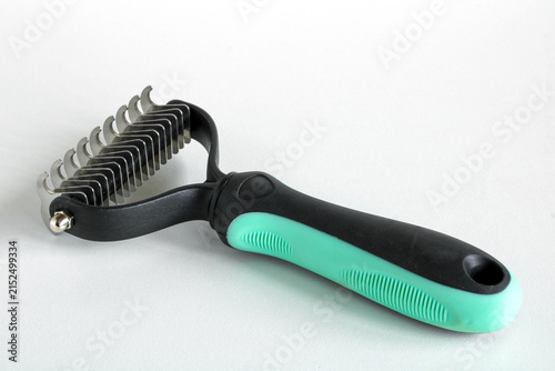Pet Grooming Tool for Removing Tangled Fur and Mats from Cat Coat Isolated on White Background
