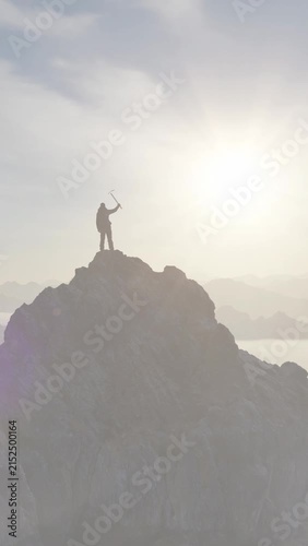 Adventurer Standing Victoriously on Mountain Peak with Ice Axe, Symbolizing Success and Achievement in 3D Render