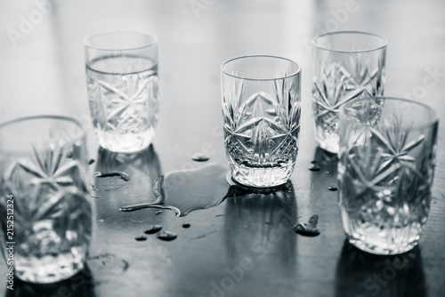Empty Shot Glasses and Spilled Alcohol on Table After Party
