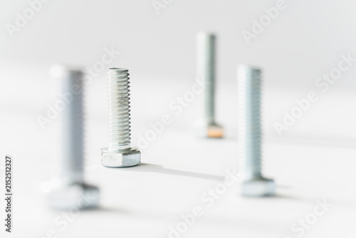 Four Metal Threaded Bolts Isolated on White Background
