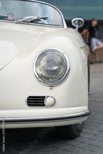 Front view of a restored vintage classic car with a well maintained bodywork
