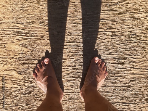 Bare Feet Standing on Textured Sandy Ground
