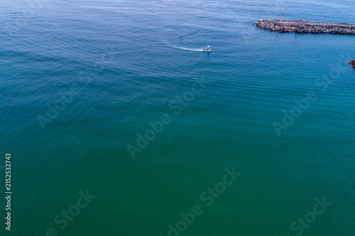 Aerial view of boat in sea and breakwater The Concept of sea and navigation