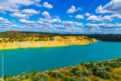 Lake with sandy shore in the abandoned coal quarry