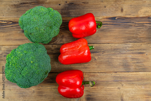 Green broccoli cabbage and bell pepper on wooden background. Healthy eating. Top view