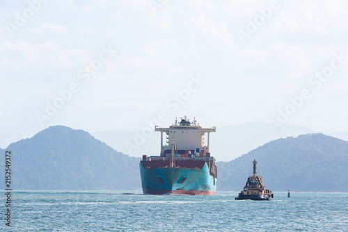 Container ship escorted by tugboat in Santos Bay, Brazil