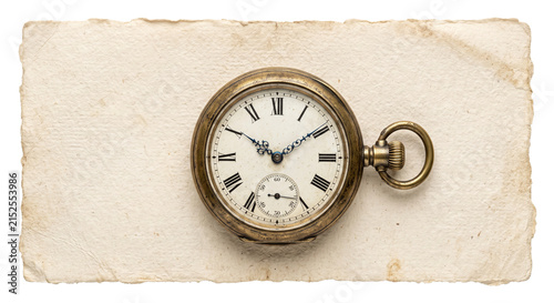 Fotografie Antique pocket watch resting on aged parchment paper with a torn edge