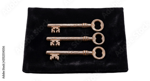 Obraz na płótnie Three antique skeleton keys arranged on a black velvet surface