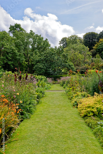 Vibrant Mixed Flower Herbaceous Border Along Curved Grass Path
