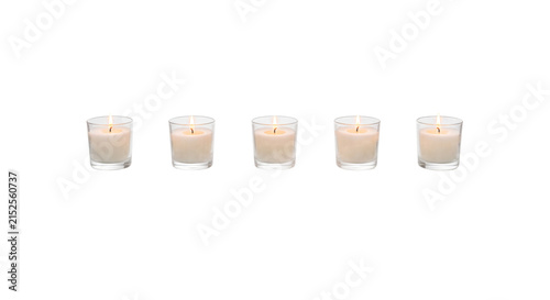Obraz na plátně Five lit votive candles in glass holders arranged in a row
