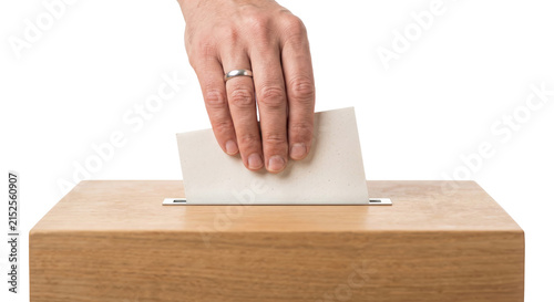 Bild auf Leinwand Hand casting a ballot into a wooden ballot box during an election