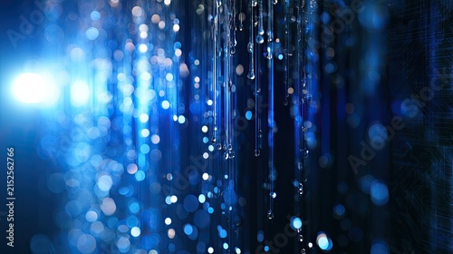 Abstract blue background with glowing bokeh, light streaks, and falling water droplets