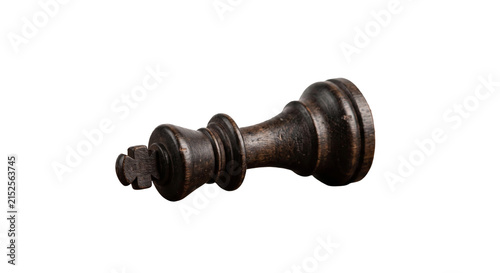 Foto Dark wooden chess king piece lying on its side, isolated on white background