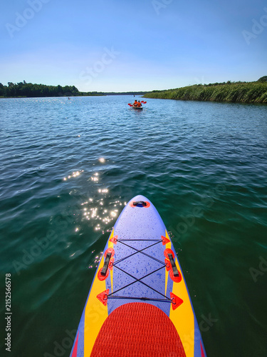Stand up paddle board on a sunny lake in Poland