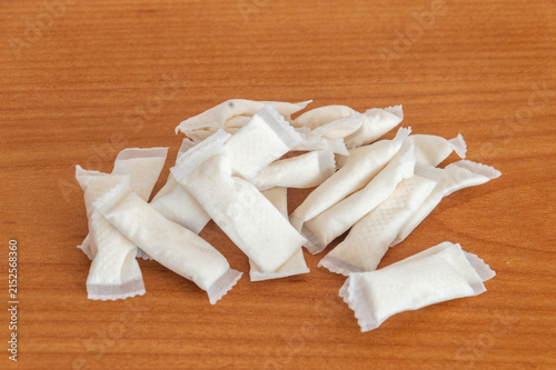 Manu nicotine snus bags on wooden table.