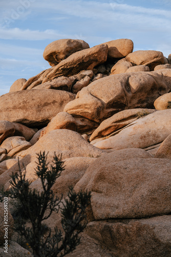 Dramatic granite rock formations illuminated by warm evening light in Joshua Tree National Park, California
