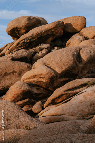 Dramatic granite rock formations illuminated by warm evening light in Joshua Tree National Park, California