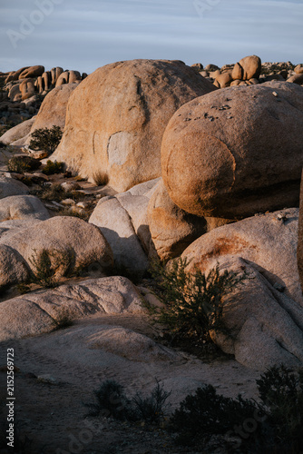 Dramatic granite rock formations illuminated by warm evening light in Joshua Tree National Park, California