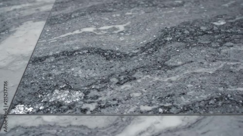 Elegant Marble Texture featuring grey and white polished stone tiles with natural veining, ideal for interior design backgrounds.