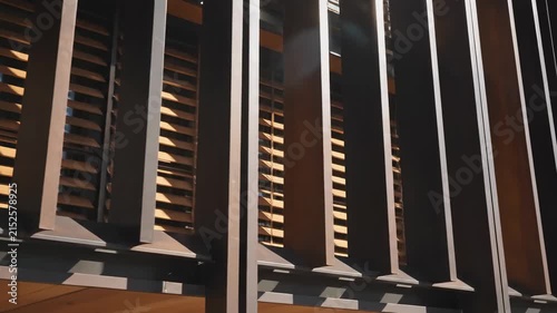 Modern Architectural Detail of Vertical Metal Fins and Wooden Slats for Design Projects.
