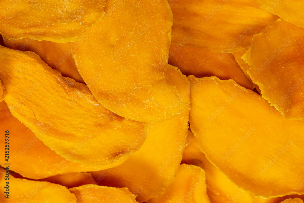 Fototapeta premium Dry tasty mango slices isolated on a white background.