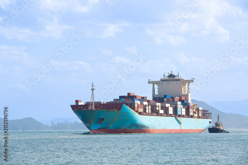 Container ship escorted by tugboat in Santos Bay, Brazil