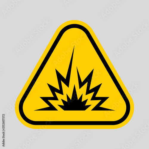 Cuadro en lienzo Yellow triangular warning sign with a black explosion symbol, representing explosive danger, hazard, and safety precautions