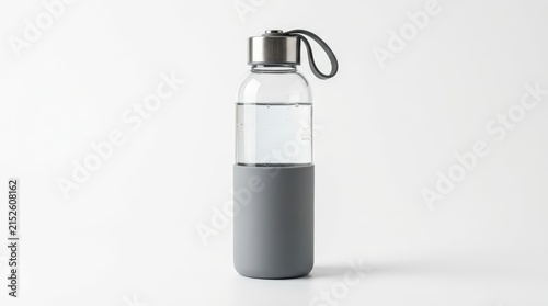Minimalist glass water bottle with grey silicone sleeve, reusable eco-friendly drinkware on white background, modern glass carafe for fitness