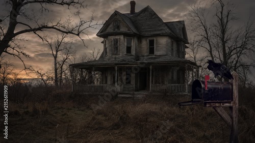 Spooky abandoned old house with Raven