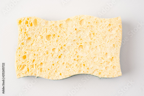 Yellow wavy kitchen sponge isolated on white background.
