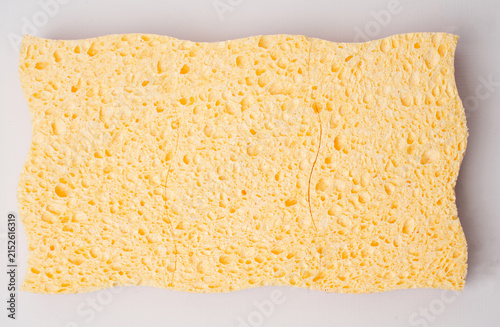 Yellow wavy kitchen sponge isolated on white background.