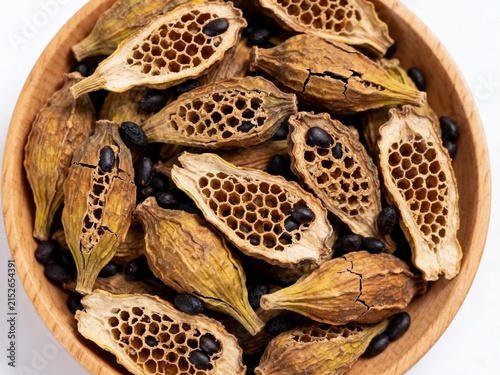 Dried Mushroom Slices in Wooden Bowl on White Background