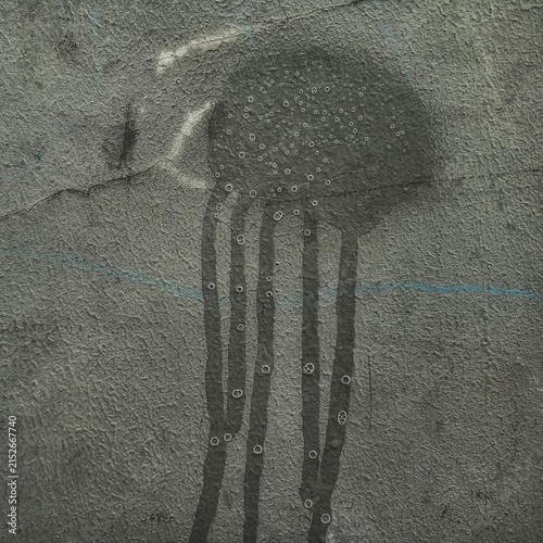 Jellyfish silhouette painted with bubbles on a textured concrete wall.