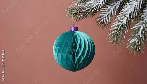 Teal Honeycomb Paper Christmas Ornament Hanging on Frosted Pine Branch