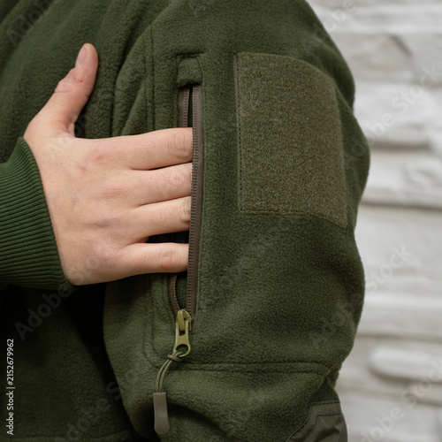 Person Wearing Green Fleece Jacket with Sleeve Pocket