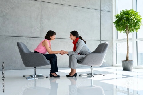 Business Meeting with Two Women in Modern Office