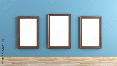 Three empty picture frames on blue wall