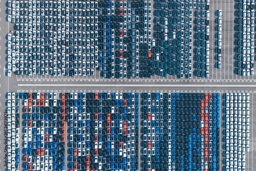Aerial top‑down view of massive new car storage lot with neatly arranged vehicles