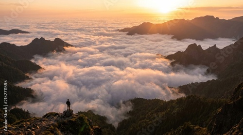 majestic sea of clouds covering deep valley during golden sunset