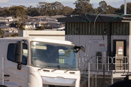 фотографія Electricity distribution switchroom beside expanding suburban housing with fence