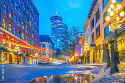 Famous steam clock emitting plume of steam on historic brick street during twilight in Gastown, Vancouver