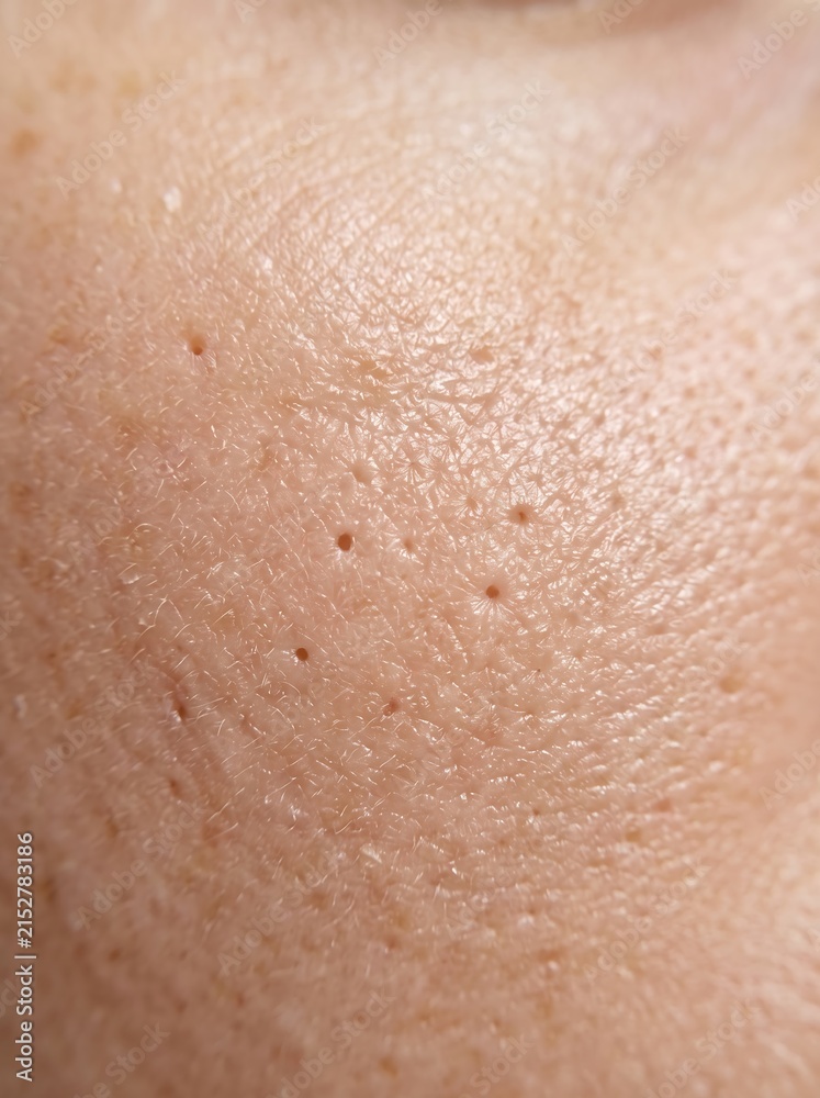 Fototapeta premium Extreme macro view of human facial skin showing natural potrait texture and open pores for dermatology articles, skincare marketing, and medical educational materials