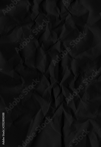 Fotografía Black crumpled paper texture with dramatic shadows provides a dark aesthetic background for moody graphic design projects requiring depth and organic tactile folded visual elements