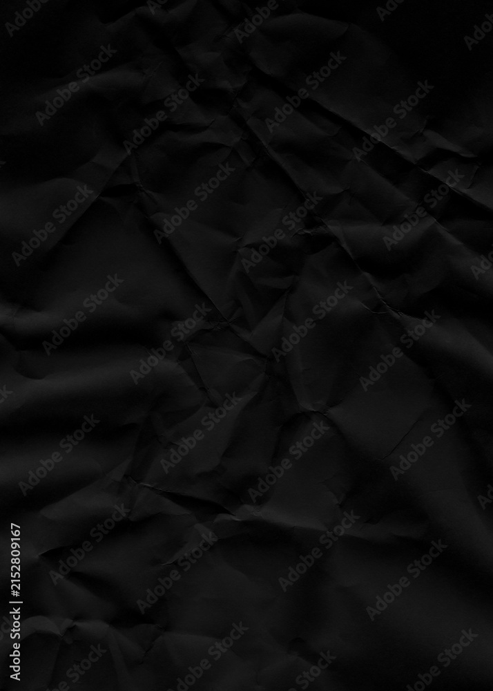 Obraz premium Black crumpled paper texture surface features dark matte folds with shadows for minimalist artistic background design projects requiring moody aesthetic depth or dramatic industrial effect.