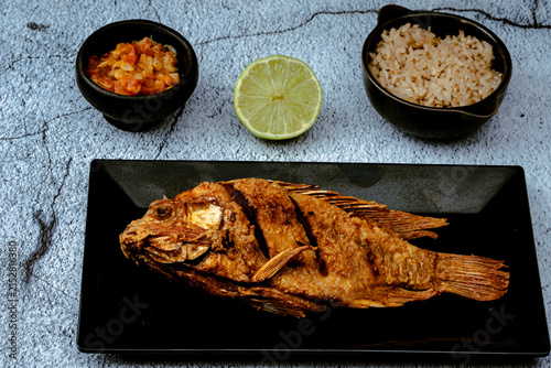 Fried tilapia fish with coconut rice and stew